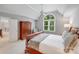 Bright main bedroom with a large window, vaulted ceilings, and wood furnishings at 14314 Lissadell Cir, Charlotte, NC 28277