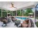 Screened patio featuring comfortable seating with a view of the sparkling pool and landscaped backyard at 14314 Lissadell Cir, Charlotte, NC 28277