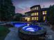 The backyard features a large in-ground pool, hot tub, screened in porch and a brick home at 14314 Lissadell Cir, Charlotte, NC 28277