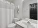 Clean bathroom with a white shower curtain, fixtures, and a storage shelf at 14723 Sapphire Ln, Pineville, NC 28134