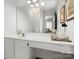 Bathroom featuring a large mirror, clean vanity, and decorative accents at 14723 Sapphire Ln, Pineville, NC 28134