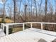 White deck overlooking a large wooded backyard, perfect for outdoor entertaining at 14723 Sapphire Ln, Pineville, NC 28134