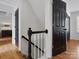 Bright hallway featuring hardwood floors, white walls, and contemporary black doors at 14723 Sapphire Ln, Pineville, NC 28134