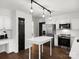 Bright kitchen with stainless appliances, stylish lighting, and black door accents at 14723 Sapphire Ln, Pineville, NC 28134