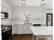 Bright kitchen featuring quartz countertops, stainless appliances, and white cabinets at 14723 Sapphire Ln, Pineville, NC 28134