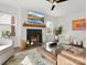 Bright living room showcasing a fireplace, mantel, lots of natural light, and comfortable furnishings at 14723 Sapphire Ln, Pineville, NC 28134