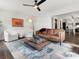 Inviting living room with a modern ceiling fan, stylish rug, and comfortable seating arrangement at 14723 Sapphire Ln, Pineville, NC 28134