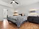 Comfortable main bedroom with a ceiling fan, tray ceiling and neutral decor at 14723 Sapphire Ln, Pineville, NC 28134