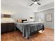 Comfortable main bedroom with a ceiling fan, tray ceiling and neutral decor at 14723 Sapphire Ln, Pineville, NC 28134