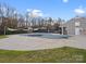 Community pool with a closed cover, surrounded by shade structures, trees, and a building at 14723 Sapphire Ln, Pineville, NC 28134