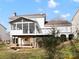 Back of house with large screened porch and a lower-level patio at 14723 Sapphire Ln, Pineville, NC 28134