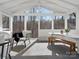 Relaxing sunroom featuring a vaulted ceiling, comfortable seating, and outdoor views at 14723 Sapphire Ln, Pineville, NC 28134