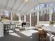 Relaxing sunroom with views of the outdoors, vaulted ceilings, and stylish furniture at 14723 Sapphire Ln, Pineville, NC 28134