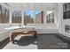 Bright sunroom with ample seating, charming decor, and bench seating at 14723 Sapphire Ln, Pineville, NC 28134