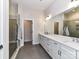 Modern bathroom with a large vanity, double sinks, and a glass-enclosed shower at 15140 Rocky Bluff Loop, Davidson, NC 28036
