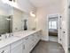 Bright bathroom with a double sink vanity and walk-in glass shower at 15140 Rocky Bluff Loop, Davidson, NC 28036