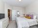 Bright bedroom with white iron bed frame, accent pillows, and natural light at 15140 Rocky Bluff Loop, Davidson, NC 28036