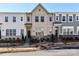 Charming townhome featuring a landscaped front yard and classic architectural details at 15140 Rocky Bluff Loop, Davidson, NC 28036