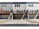 Rear view of townhomes with decks, garages and tidy landscaping of decorative stones at 15140 Rocky Bluff Loop, Davidson, NC 28036