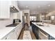 Bright and airy kitchen featuring white cabinets, stainless steel appliances, and a large island at 15140 Rocky Bluff Loop, Davidson, NC 28036