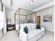 Bright main bedroom featuring a four-poster bed, sitting area, and neutral decor at 15140 Rocky Bluff Loop, Davidson, NC 28036