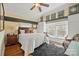 Cozy bedroom with built-in storage and a window seat, complemented by hardwood floors and a stylish ceiling fan at 1740 12Th Street Nw Dr, Hickory, NC 28601