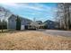 Exterior view of home featuring mature trees and parking spaces at 1740 12Th Street Nw Dr, Hickory, NC 28601