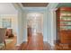 Elegant hallway with hardwood floors, classic columns, and arched doorways at 1740 12Th Street Nw Dr, Hickory, NC 28601