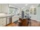 Bright kitchen featuring white cabinetry, dark countertops, and a central island with seating at 1740 12Th Street Nw Dr, Hickory, NC 28601