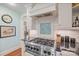 Modern kitchen features a stainless steel stove, hood and granite countertops, with colorful backsplash tile at 1740 12Th Street Nw Dr, Hickory, NC 28601