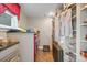 Well-organized laundry room features shelving, granite countertop, and a modern, red washer and dryer set at 1740 12Th Street Nw Dr, Hickory, NC 28601