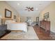 A beautiful main bedroom with a sitting area, ceiling fan, and hardwood floors at 1740 12Th Street Nw Dr, Hickory, NC 28601