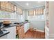 Butler's pantry with a granite countertop, abundant cabinet space, natural light, and hardwood flooring at 1740 12Th Street Nw Dr, Hickory, NC 28601