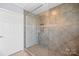 Walk-in shower with tile surround, glass door, and built-in shelving at 1740 12Th Street Nw Dr, Hickory, NC 28601