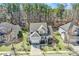 An aerial view of a home nestled among mature trees, showcasing its roof, yard, and surrounding neighborhood at 17609 Caddy Ct, Charlotte, NC 28278