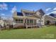 View of the backyard featuring a covered deck, green lawn and partial fencing against blue skies at 17609 Caddy Ct, Charlotte, NC 28278
