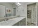 Well-lit bathroom featuring double sinks, modern fixtures, a decorative mirror, and a tiled shower/tub at 17609 Caddy Ct, Charlotte, NC 28278