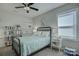 Relaxing bedroom featuring a full bed with starfish themed comforter, a ceiling fan and stylish décor at 17609 Caddy Ct, Charlotte, NC 28278