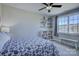 Inviting bedroom with a large window, a ceiling fan, a full bed and simple bookshelves, offering a restful retreat at 17609 Caddy Ct, Charlotte, NC 28278