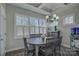 Bright dining room with large window, chandelier, and modern furnishings at 17609 Caddy Ct, Charlotte, NC 28278