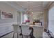 Refined dining room with modern chandelier, wainscoting, and large mirror, perfect for entertaining guests at 17609 Caddy Ct, Charlotte, NC 28278