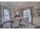 Elegant dining room with tray ceilings, modern lighting, and stylish chairs, offering a sophisticated ambiance at 17609 Caddy Ct, Charlotte, NC 28278