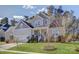 Beautiful two-story home with manicured lawn and classic architectural details under a partially cloudy sky at 17609 Caddy Ct, Charlotte, NC 28278