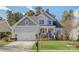 Charming two-story home with a well-maintained lawn, a two-car garage, and a welcoming front porch at 17609 Caddy Ct, Charlotte, NC 28278
