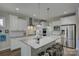 Bright kitchen featuring white cabinets, stainless steel appliances, and a large island with bar seating at 17609 Caddy Ct, Charlotte, NC 28278