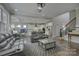 Spacious living room with hardwood floors, gray furniture, an open layout, and stairs to the second floor at 17609 Caddy Ct, Charlotte, NC 28278