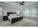 Relaxing main bedroom featuring tray ceilings, plush carpet, and ample natural light with bedside tables and lamps at 17609 Caddy Ct, Charlotte, NC 28278