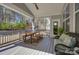 Covered porch with outdoor dining table and view of the backyard at 17609 Caddy Ct, Charlotte, NC 28278