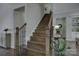 Elegant staircase featuring dark wood steps, iron spindles, and wood railing, offering a stylish transition between floors at 17609 Caddy Ct, Charlotte, NC 28278