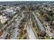 Aerial view featuring townhomes bordering a creek, set amongst a backdrop of lush greenery and city skyline at 19827 Henderson Rd # L, Cornelius, NC 28031